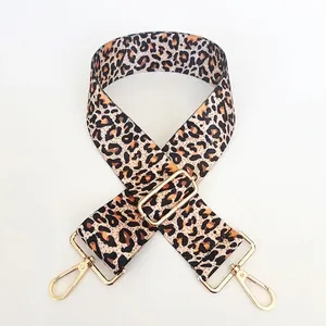 Detail of adjustable leopard print bag strap with high-quality gold metal buckles