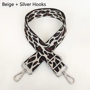 Detail of adjustable off-white leopard print bag strap with silver metal swivel hooks