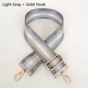 Adjustable light grey striped shoulder strap with gold metal hooks for handbags