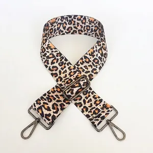 Detail showing colorful leopard print fabric texture and gunmetal swivel snap hooks