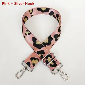Close-up of pink leopard print wide bag strap with silver metal hooks and buckle