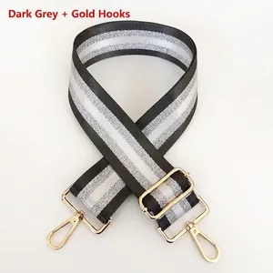 Adjustable dark gray and silver striped wide bag strap with durable gold metal clasps