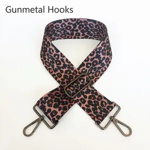 Close-up of leopard print shoulder strap with adjustable gunmetal buckle and swivel hooks