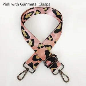 Macro detail of pink leopard print wide strap with gunmetal swivel hook and buckle