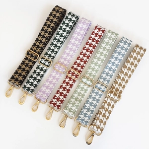 Detail of adjustable houndstooth shoulder straps with golden metal hooks in multiple colors