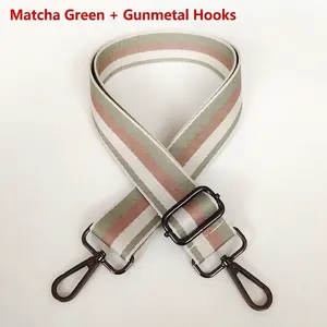 Detail of matcha green striped bag strap with gunmetal swivel hooks and adjustable buckle
