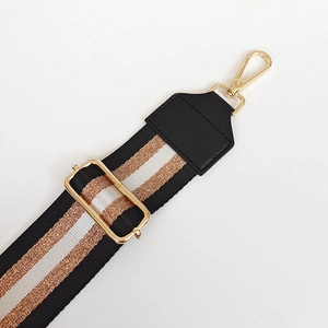 Detail of adjustable 5cm nylon strap with metallic gold silver stripes and gold hooks