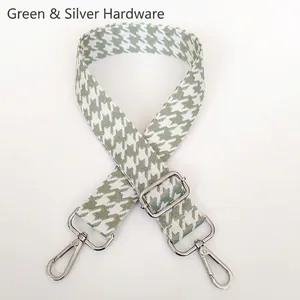 Detail of matcha green houndstooth jacquard bag strap with silver metal swivel hooks