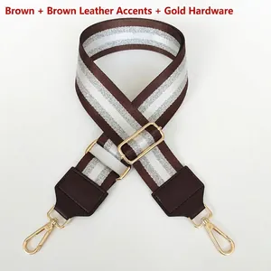 Detail of coffee woven bag strap with silver threads and gold metal swivel snap hooks