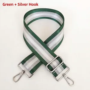Detail of adjustable green and silver striped bag strap with durable metal lobster hooks