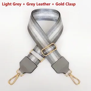 Detail of adjustable nylon strap with silver glitter stripes and gold metal hooks