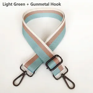 Close-up of green and coffee striped canvas strap with adjustable gunmetal metal hooks