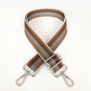 Detail of adjustable khaki and brown striped nylon shoulder strap with silver metal hooks