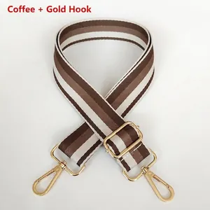 Detail of thickened coffee striped canvas bag strap with golden metal swivel hooks