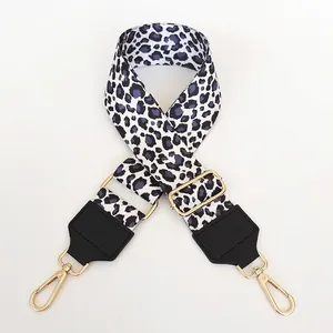 Close-up of 5cm wide leopard print bag strap with golden hardware and black leather