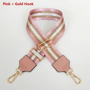 Detailed view of adjustable pink and gold striped nylon bag strap with metal hooks