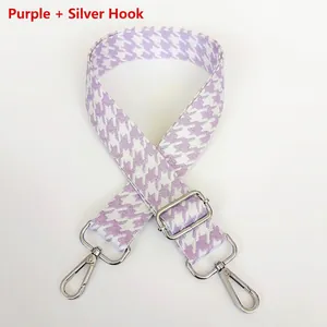 Detail of purple houndstooth wide bag strap with silver metal lobster clasps