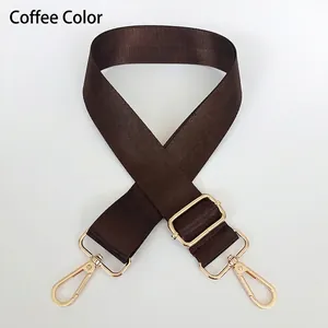 Macro view of adjustable coffee nylon strap with polished light gold metal hooks