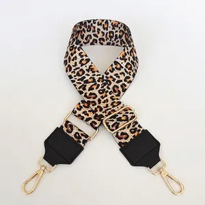 Close-up of 5cm wide leopard print bag strap with golden buckles and black leather ends