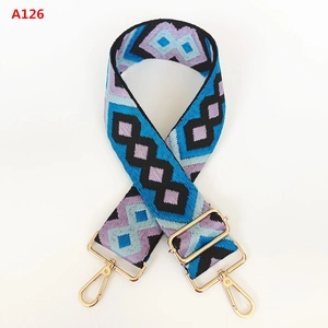 Detail of colorful geometric diamond pattern shoulder strap with golden metal lobster hooks