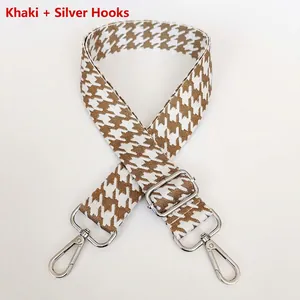 Close-up of khaki houndstooth bag strap with polished silver metal swivel hook