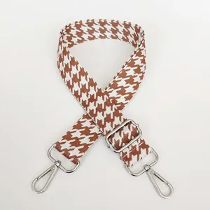 Detail of light brown houndstooth strap with adjustable polished silver metal hooks
