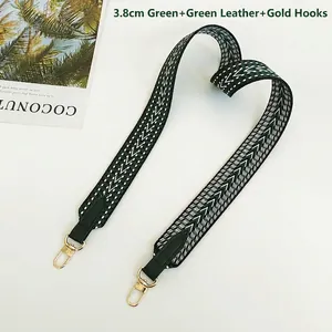 Detail view of 3.8cm wide green woven shoulder strap with gold hooks and leather ends