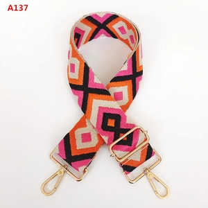 Detail of adjustable colorful geometric diamond jacquard canvas strap with gold swivel hooks