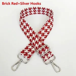Detail of brick red houndstooth woven replacement strap with silver metal hooks and buckle