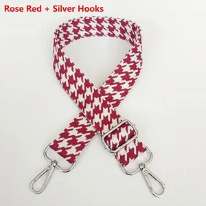 Close-up of rose red houndstooth jacquard bag strap with silver metal swivel hooks