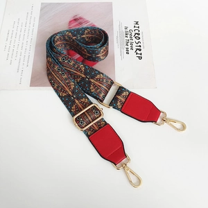 Detail of bohemian woven bag strap with blue geometric patterns and red leather ends