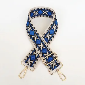 Detail of bohemian geometric rhombus woven canvas bag strap with gold metal lobster clasps