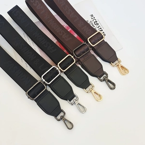 Detail of five nylon bag straps with Fashion & Classic text and metal buckles