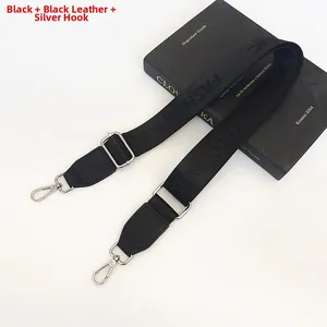 Detail of adjustable black nylon shoulder strap with silver hooks and FASHION text