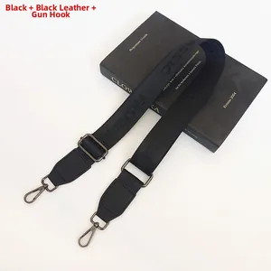 Detail of adjustable black nylon shoulder strap with gunmetal hooks and leather finish