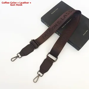 Detail of coffee nylon bag strap with fashion lettering and gunmetal swivel hooks