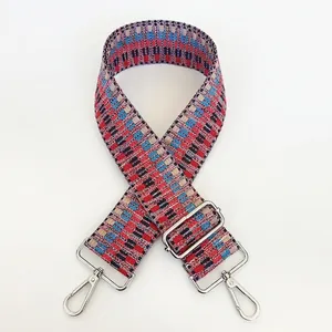 Detail of colorful geometric woven shoulder strap with silver metal swivel hooks