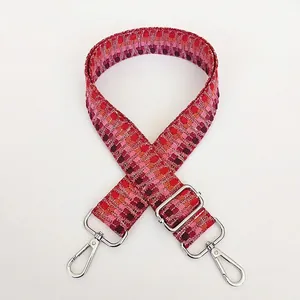 Detail of colorful geometric woven bag strap with silver metal spring hooks
