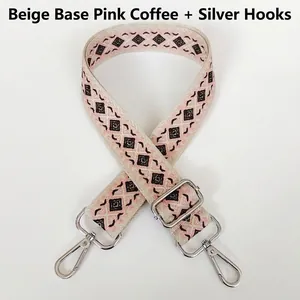 Close-up of geometric jacquard canvas bag strap with silver metal swivel hooks
