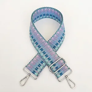 Detail of adjustable woven bag strap B43 with purple geometric pattern and silver hooks