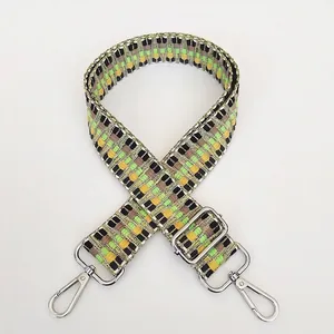 Macro shot of colorful woven guitar-style purse strap with durable silver metal hook