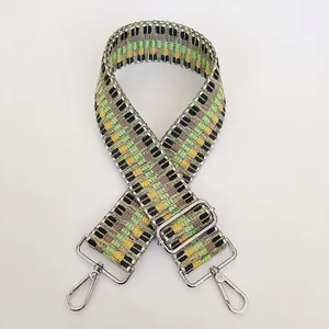 Detail view of woven adjustable guitar style purse strap with silver metal swivel hooks