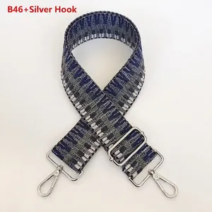 Detail of B46 wide woven bag strap with silver hook and blue geometric pixel pattern