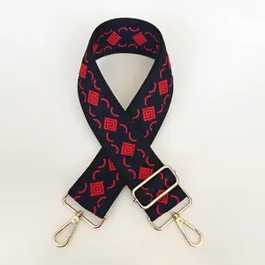Thick canvas shoulder strap with navy and red jacquard diamond pattern and gold metal hooks