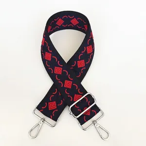 Detail of adjustable thick canvas strap with ethnic jacquard pattern and silver hooks