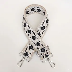 Detail of adjustable canvas bag strap with black and gray geometric diamond pattern