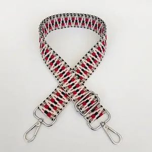 Detail of red and black geometric woven strap with adjustable silver metal hooks