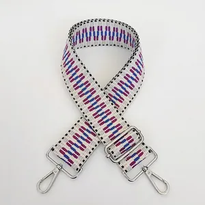 Detail of geometric woven shoulder strap with silver hooks and adjustable buckle length