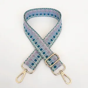 Close-up of geometric embroidered woven strap B34 with gold hooks for handbags