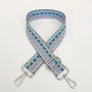 Detail of adjustable embroidered wide canvas strap with blue geometric jacquard pattern